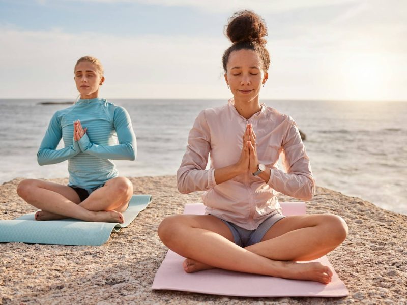 yoga-meditation-and-friends-outdoor-on-a-beach-together-for-mental-health-or-wellness-in-summer-e.jpg